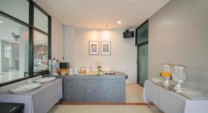 a large room with a counter with glasses on it at C2U Hotel Uthai Thani in Ban Khok Mo