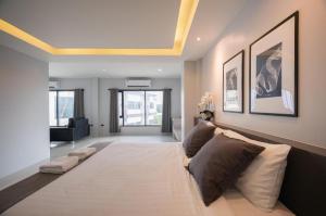 a living room with a large bed and a couch at C2U Hotel Uthai Thani in Ban Khok Mo +91 photos