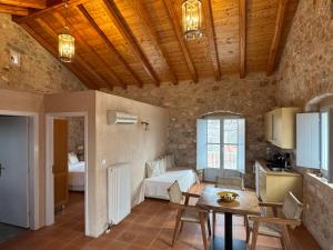 a living room with a table and a room with a couch at Balcony&Tower in Areopoli