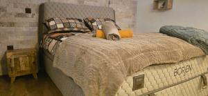 a bedroom with a large bed with a gray bedspread at Amore Grande in Samokov