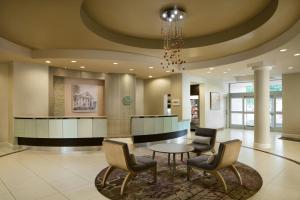 a lobby with a table and chairs and a chandelier at Residence Inn by Marriott Fairfax City in Fairfax