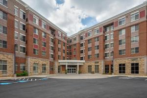 an empty parking lot in front of a large brick building at Residence Inn by Marriott Fairfax City in Fairfax