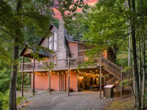 a tree house in the woods with a deck at Merlot Chateau - Views, New Hot Tub, Fire Pit, Game Room, Wi-Fi - Mins to Blue Ridge in Morganton
