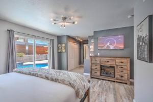 a bedroom with a bed and a tv and a fireplace at ᨒོ The Good Life - Fun Pool Escape 15 min to Strip in Las Vegas +22 photos