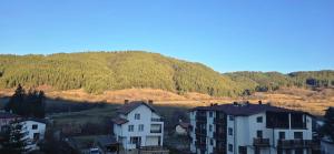 a group of houses in front of a mountain at Amore Grande in Samokov
