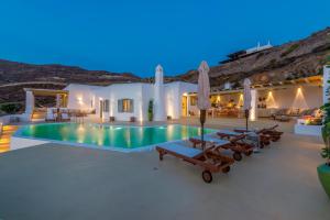 a villa with a swimming pool at night at Villa Ftelia Boheme in Ftelia