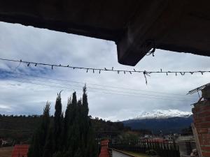 a view of a snow covered mountain from a house at 3- Departamento con terraza in Amecameca de Juárez +6 photos