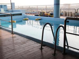 a swimming pool on top of a building at Alsafina hotel in Lahore