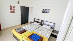 two twin beds in a room with at Redstone Hills, Diveagar in Diveagar