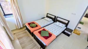 an overhead view of two beds in a room at Redstone Hills, Diveagar in Diveagar