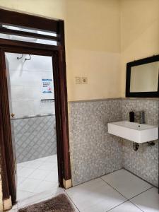a bathroom with a shower and a sink at Chill-Inn near Surabaya Zoo Syariah in Surabaya