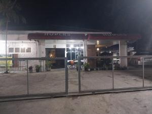 a hooters restaurant at night with a gate in front at HW Hubers Laguboti in Laguboti
