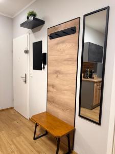 a mirror and a bench next to a door at Apartment Almtal Liebe in Viechtwang