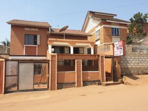 a house is under construction on a dirt road at KBK Comfort Accommodation in Kampala