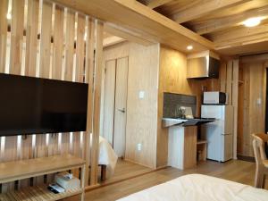 a room with a large flat screen tv on a wall at ATTA Toya - Lake Resort in Sobetsu