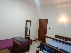 a bedroom with two beds and a dresser and a mirror at Horizon Guest Hatton in Hatton