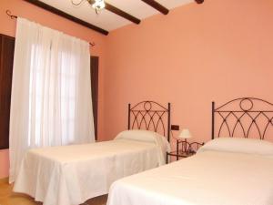Voodi või voodid majutusasutuse Hotel El Romeral toas