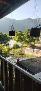 a balcony with a view of a park with trees at Villa Wong Pai Ton in Ngadisari