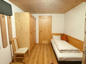 a small room with a bed and a chair at Apartment with Alpine views in Fügenberg