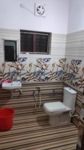 a bathroom with a toilet and a sink at Verge Hostel in Varkala
