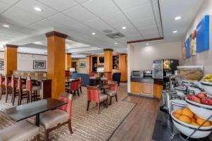 a hotel room with tables and chairs and a cafeteria at Comfort Inn & Suites in Camden