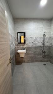 a bathroom with a sink and a toilet and a shower at Nizwa heart in Nizwa