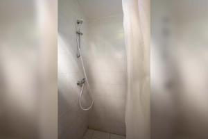 a shower with a shower curtain in a bathroom at Farm Stay Ferjančič in Vipava +17 photos