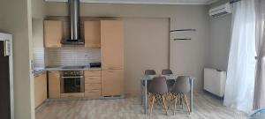 a kitchen with a table and chairs in a room at JD Maisonette for 4 in Neoi Epivates