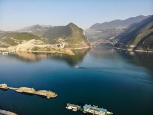 an aerial view of a large body of water with a bridge at Vienna Hotel Chongqing Wushan Municipal Government in Wushan