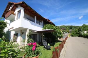 a white house with an umbrella and some flowers at Familien Themen-Appartement Freiburg in Sölden 2 Schlafzimmer in Sölden