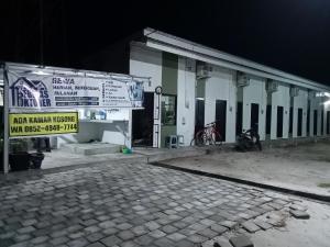 a building with a sign on the side of it at Wisma 11 Oktober in Palangkaraya