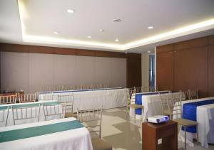 a conference room with tables and chairs in a room at Mansion Garden Hotel in Olongapo +206 photos