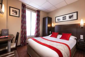 una habitación de hotel con una cama grande con almohadas rojas en Jack's Hotel, en París
