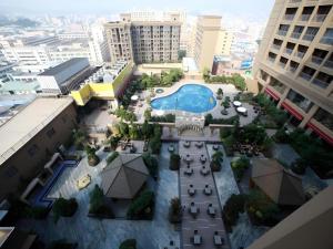 an overhead view of a courtyard with a pool in a city at Babylon Hotel in Dongguan