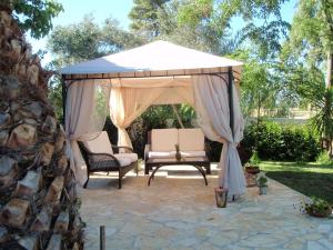 - un kiosque avec deux chaises et une table dans l'établissement Villa Olga Lounge Hotel, à Lygia
