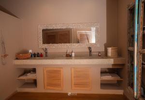 a bathroom with a sink and a mirror at Cocoa Beach Lodge sur Île Nosy Komba in Nosy Komba +53 photos
