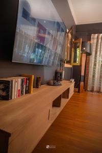 a living room with a large tv on the wall at Cocoa Beach Lodge sur Île Nosy Komba in Nosy Komba