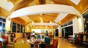 a group of people sitting at tables in a restaurant at Mekong My Tho Hotel in My Tho