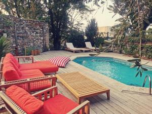 a patio with chairs and a pool with a table and chairs at Maison de la Pra in Valence