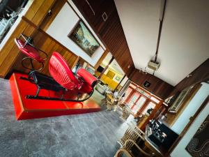 an aerial view of a living room with red chairs at Railway Lodge Motel in Taree