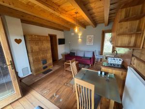 a living room with a table and a couch at Frida Farm Vendégház in Kétvölgy