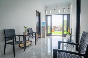 a waiting room with chairs and a table and a window at Micko Homestay, Mantrijeron "Top Rated Value" in Yogyakarta