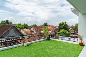 a view from the balcony of a house with green grass at Micko Homestay, Mantrijeron "Top Rated Value" in Yogyakarta