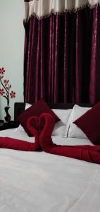 En eller flere senge i et værelse på Adb's Srirangam Homes