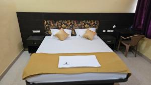 een slaapkamer met een bed met daarop een laptop bij Corcordium by ssr in Bilikere