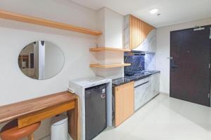 a small kitchen with a sink and a dishwasher at Apartment Amarta Studio with Living Room in Yogyakarta +8 photos