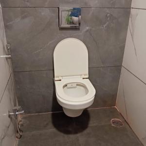 a bathroom with a white toilet in a stall at Hotel M S in Pālia +7 photos