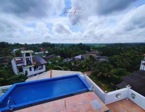 a kite flying over a house with a swimming pool at Prince House in Piliyandala