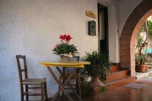 a table with flowers on it next to a building at Il Casolare della Cascata in Terni
