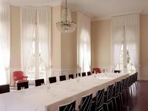 a large white room with a long table and chairs at Parker Palm Springs in Palm Springs +163 photos